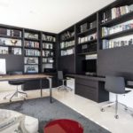 A flat screen tv sitting on top of a book shelf