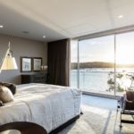 A bedroom with a bed and a chair in a room