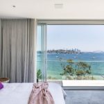 A bedroom with a bed and a large window