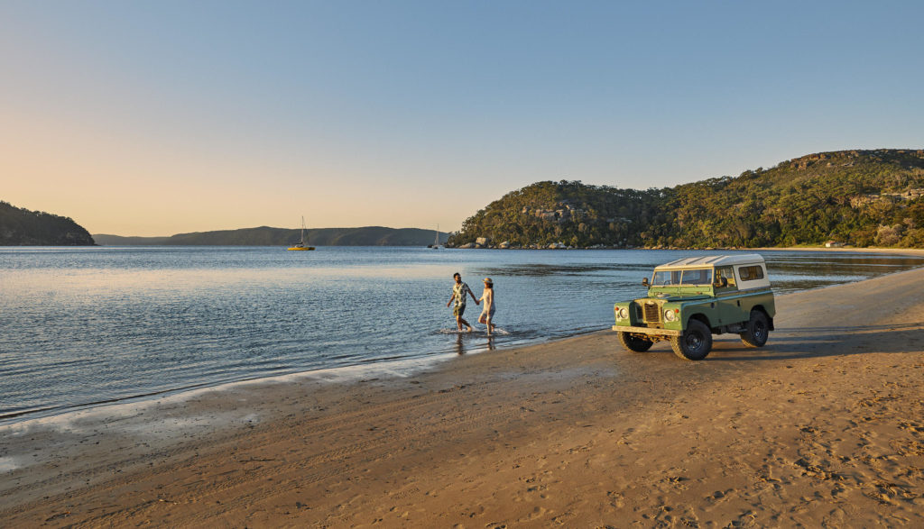 A couple of people on a beach near a body of water