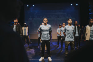 A group of people standing in front of a crowd