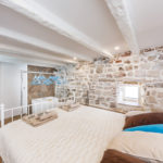 A bedroom with a bed in a room