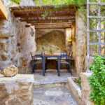 A stone bench sitting next to a fireplace