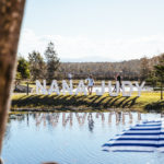 A group of people standing next to a lake