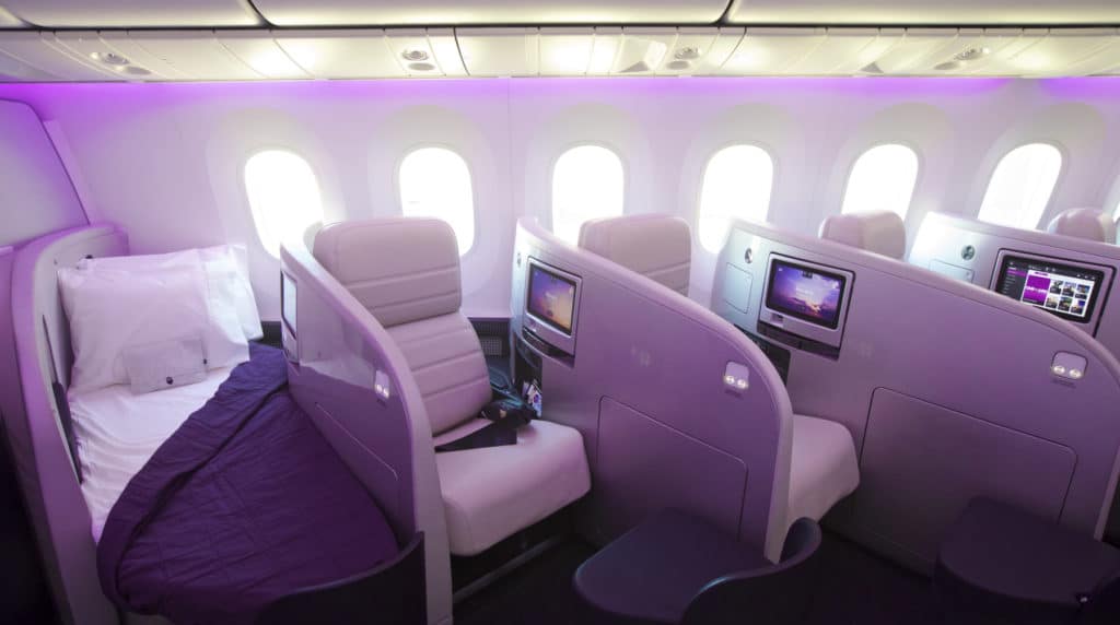 A bedroom with a purple chair