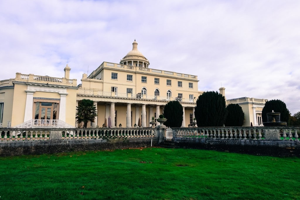 A large building with a green field