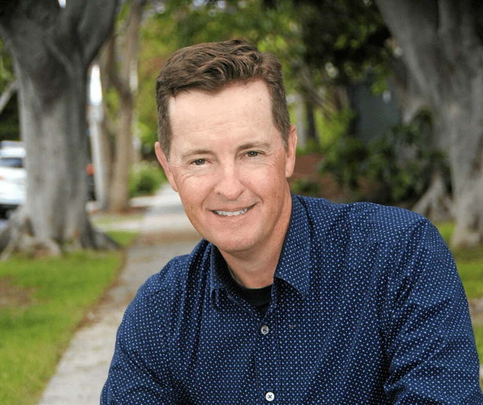 A man smiling in a park