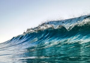 A man riding a wave on a surfboard in the ocean