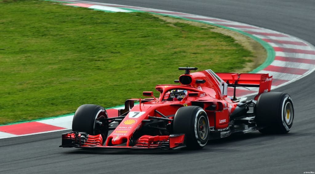 A person driving a race car on a road