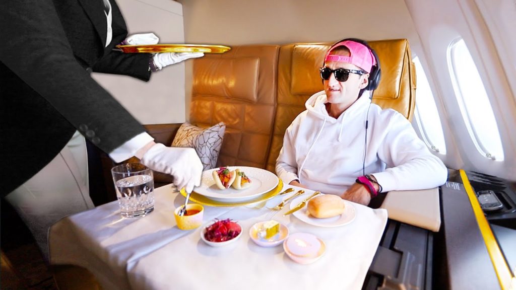 A person sitting at a table with a cake