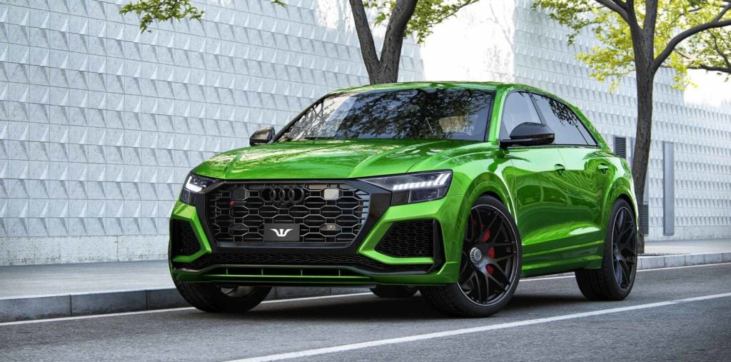 A green car parked on the side of a road
