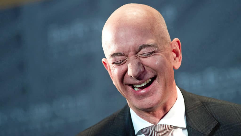 A man wearing a suit and tie smiling at the camera