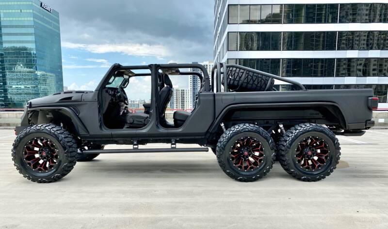 A car parked in front of a truck