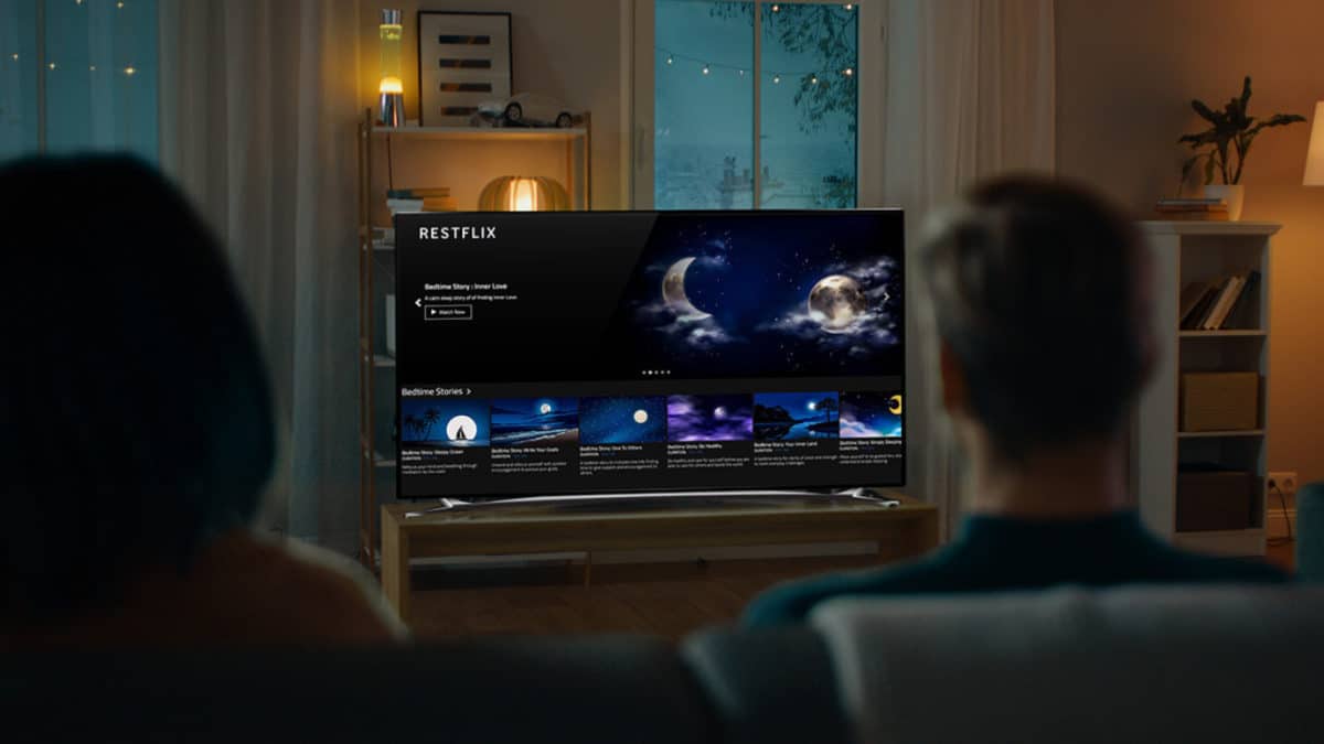A person standing in front of a television