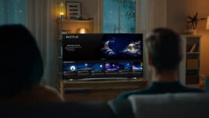 A person standing in front of a television