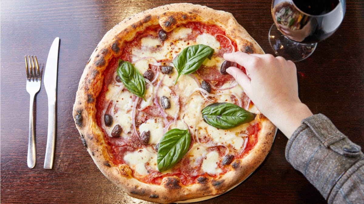 A pizza sitting on top of a wooden table