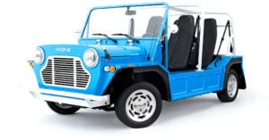 A blue truck parked next to a car