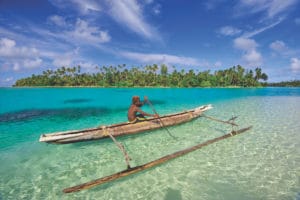 A person sitting in a boat on a body of water