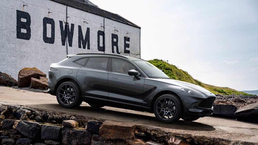 A car parked in front of a rock