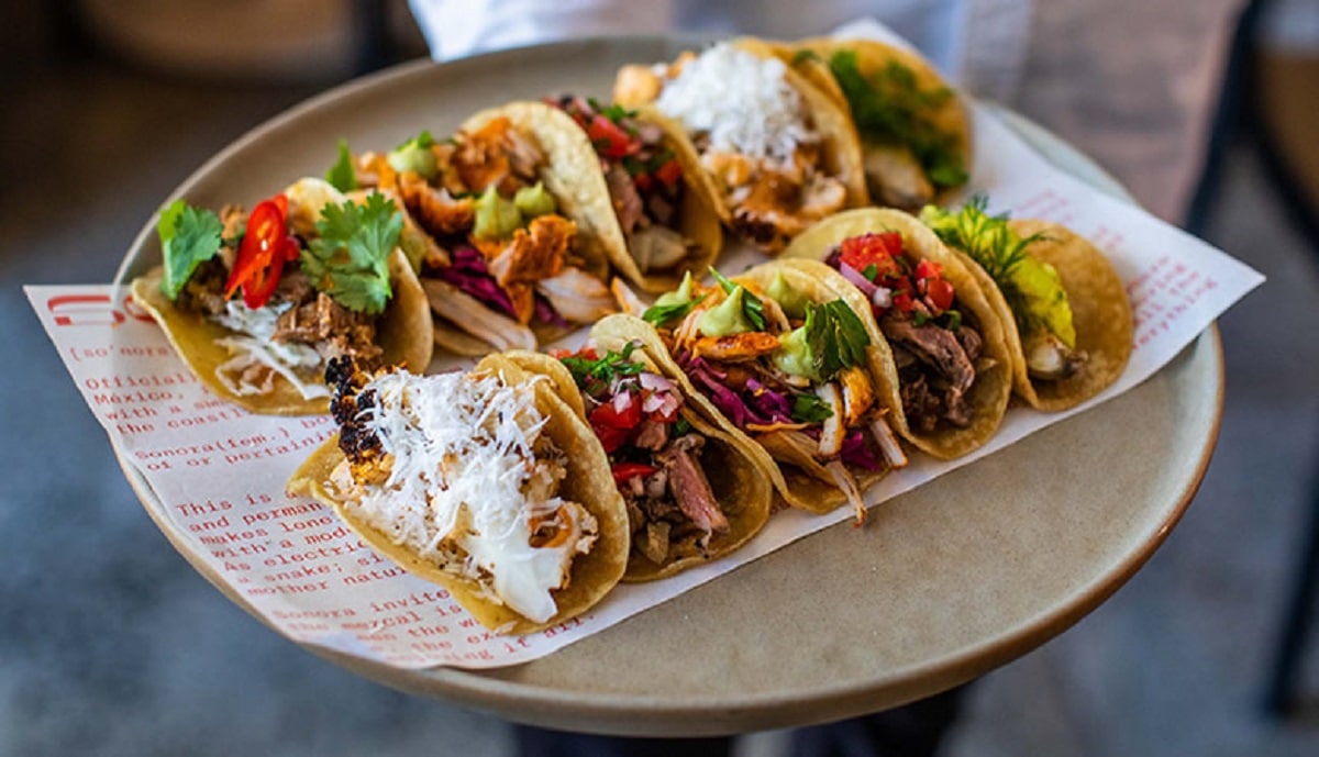 A sandwich sitting on top of a plate of food on a table