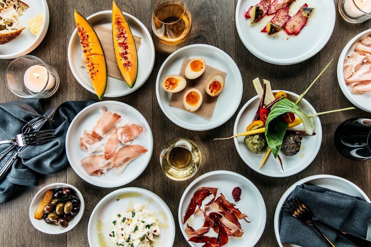 A group of people sitting at a table with a plate of food