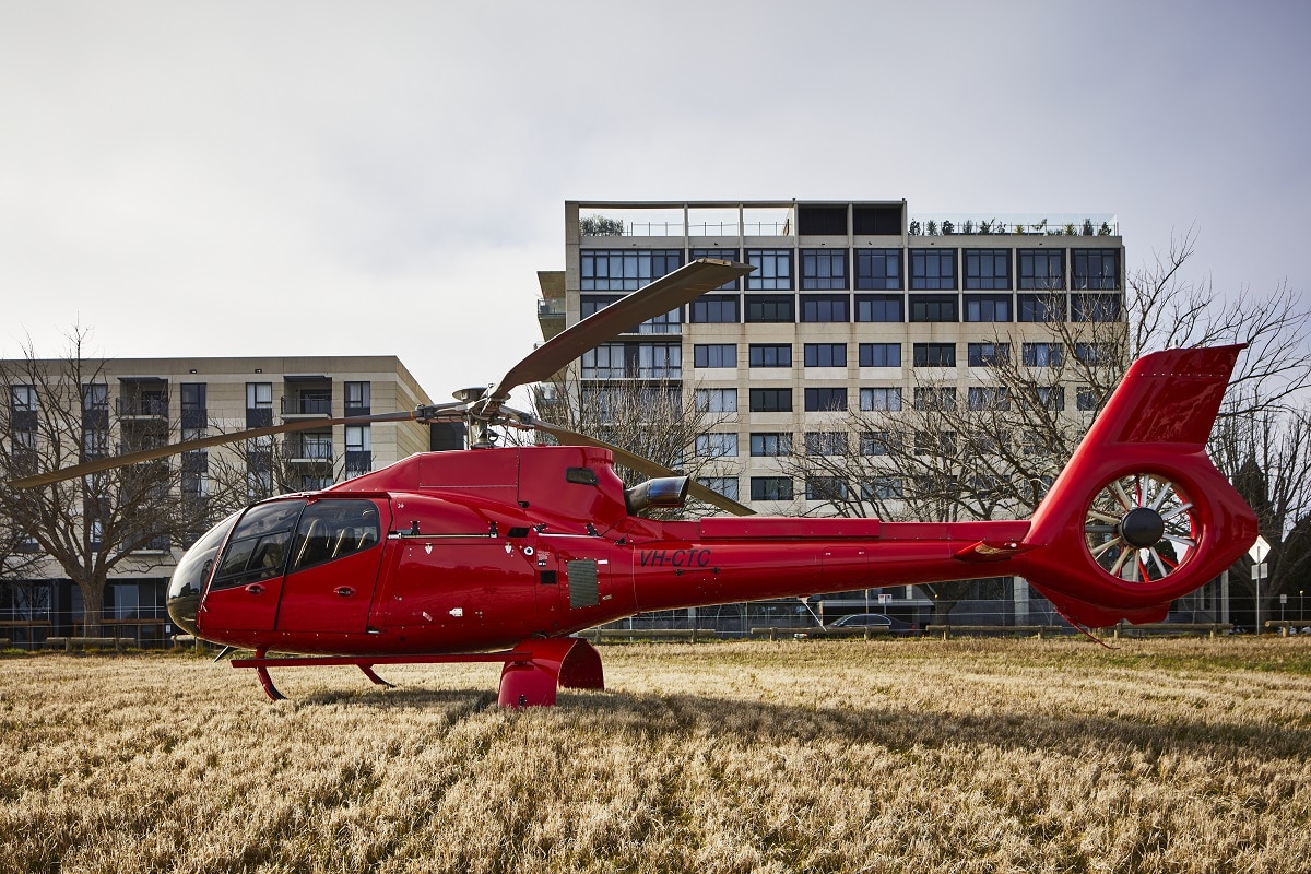 A plane sitting on top of a grass covered field