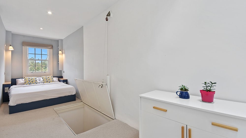 The thinnest house in England has a stylish main bedroom.