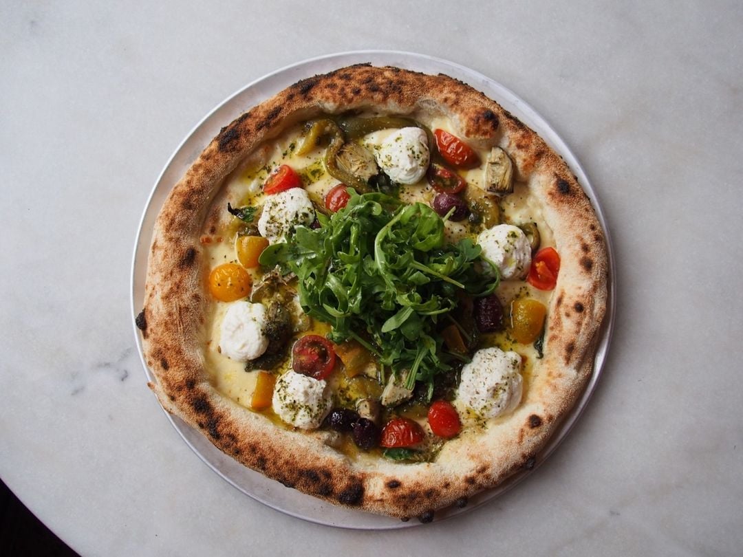 A pizza sitting on top of a plate of food