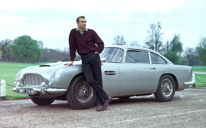 A man standing in front of a car