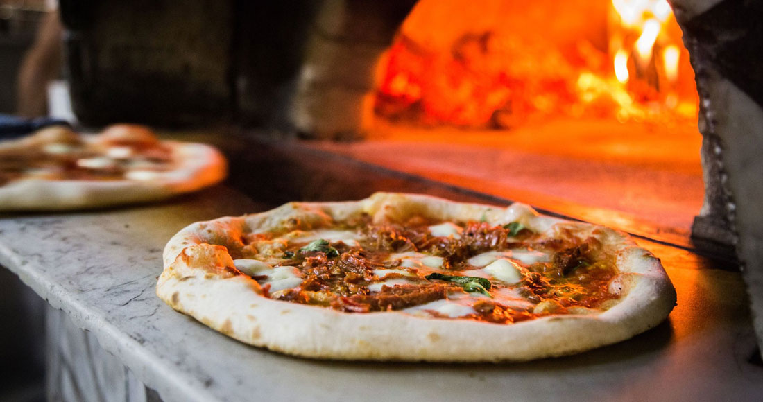 A pizza sitting on top of a wooden cutting board