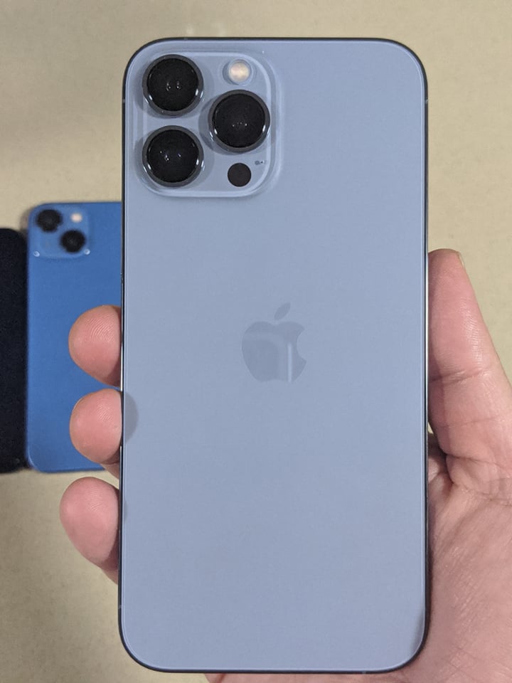 Holding the iPhone 13 Pro Max in Sierra Blue