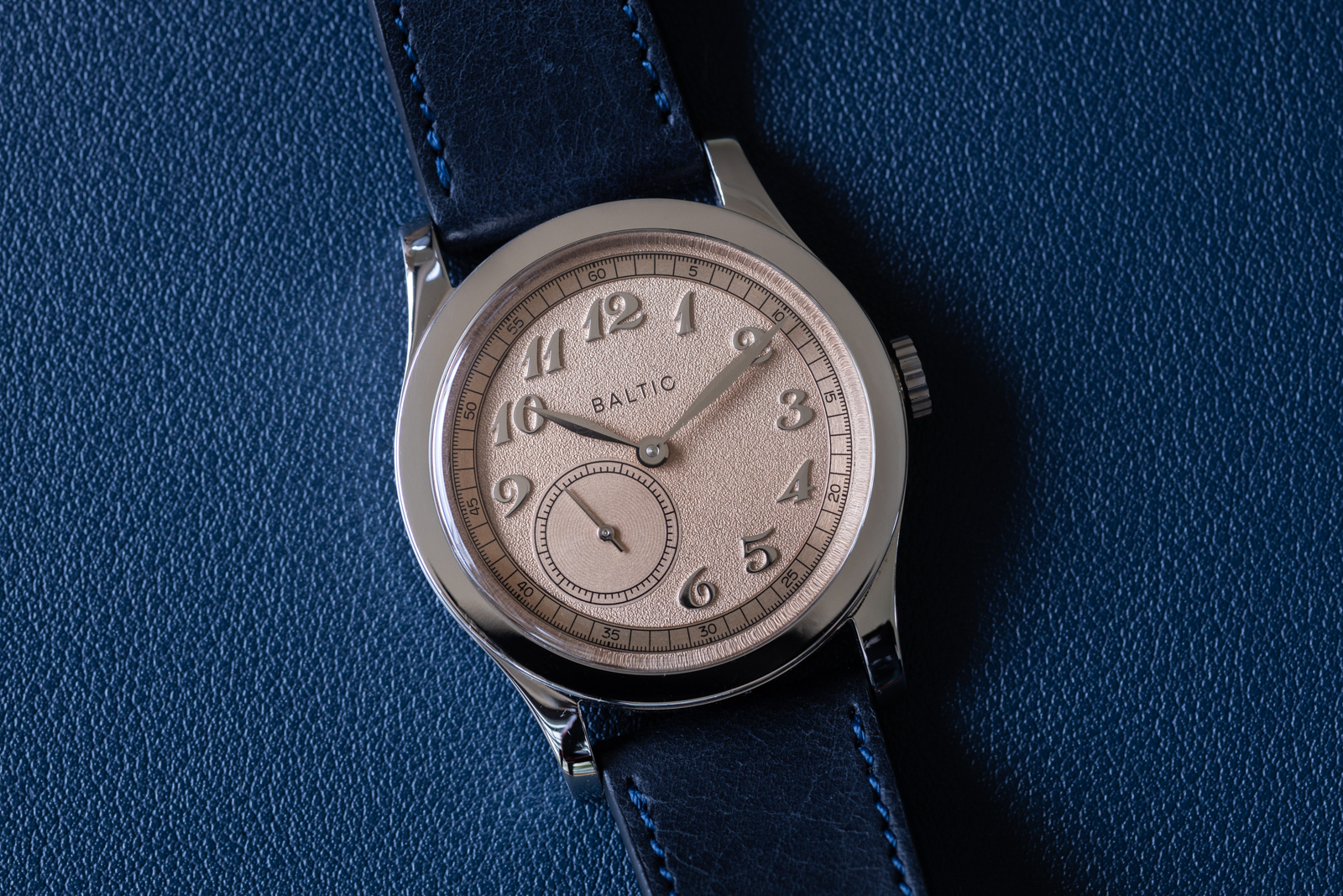 A blue clock sitting on top of a watch